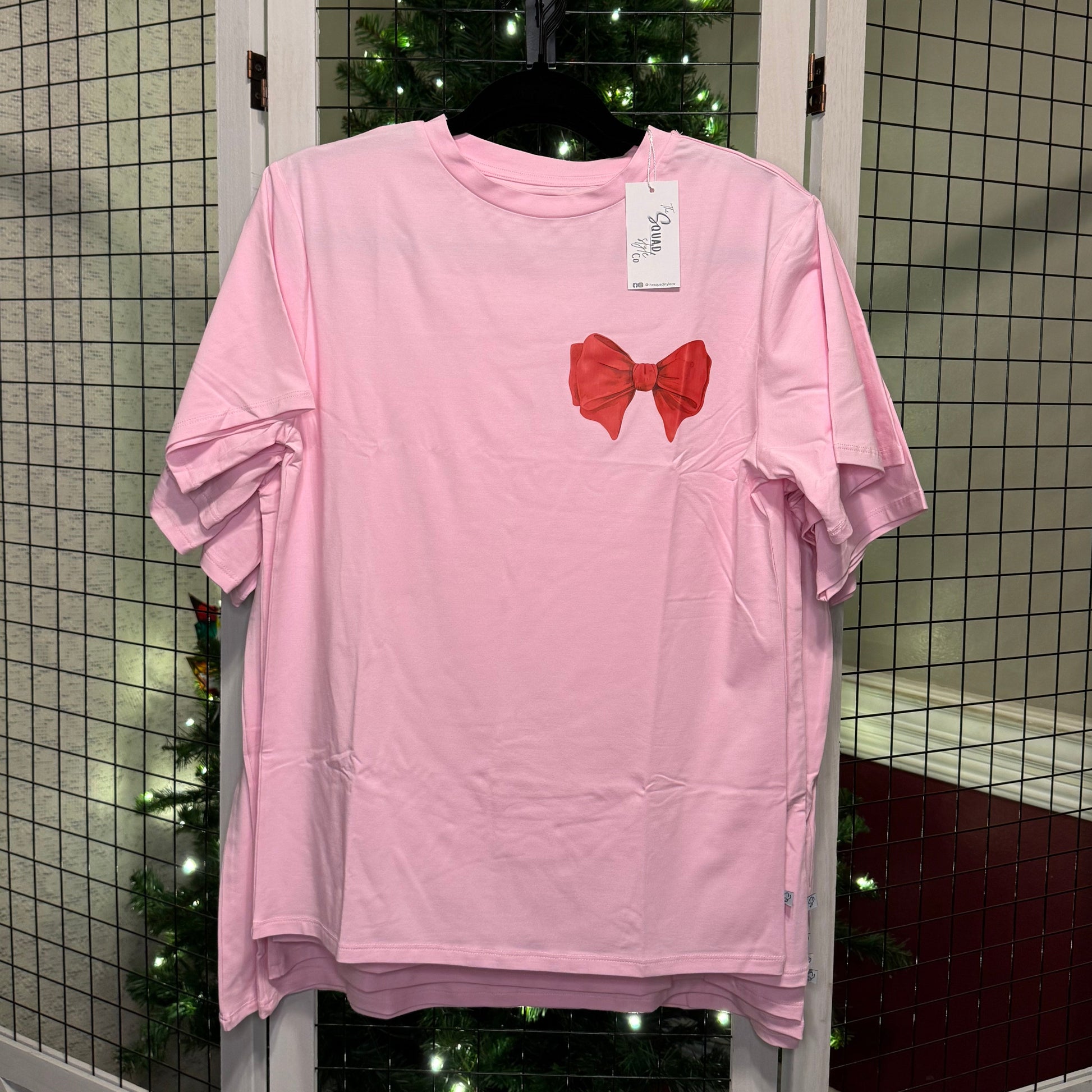 Perfect bow t shirt in front of a Christmas tree