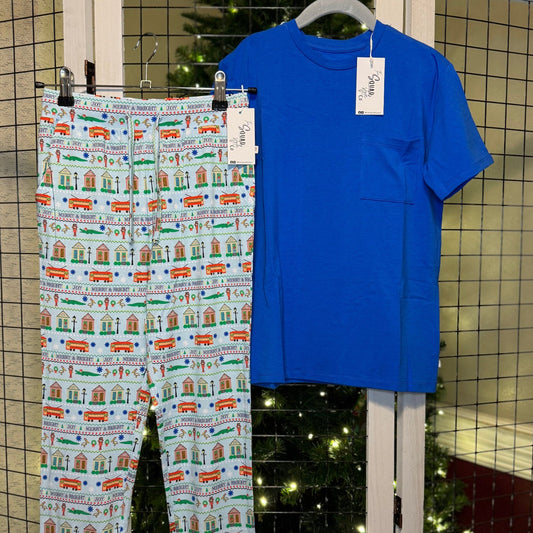 Merry Blue t-shirt and Merry NOLA pants hanging with a Christmas tree in the background.