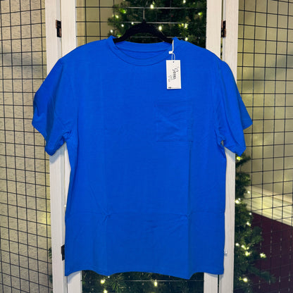 Blue t-shirt on a hanger with a Christmas tree in the background